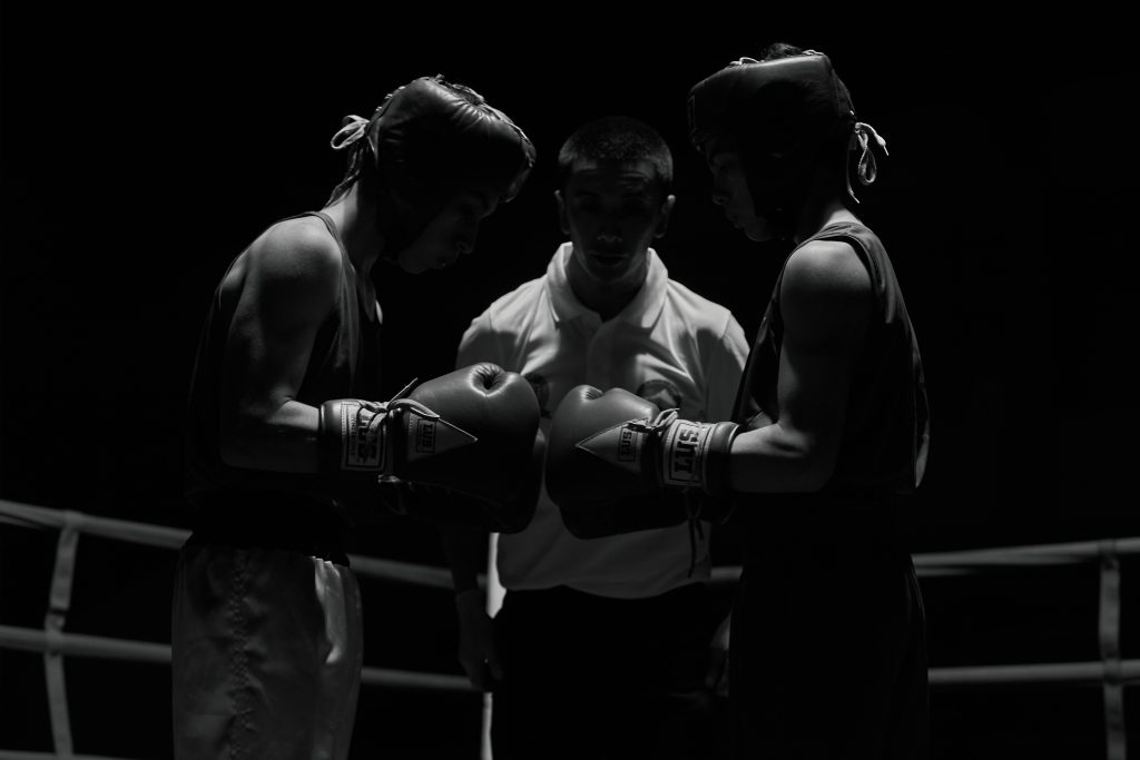 Two boxers standing in a ring