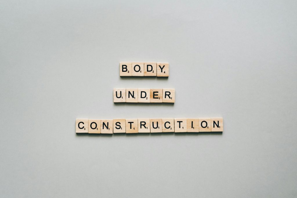 "Body under construction" written in scrabble letters