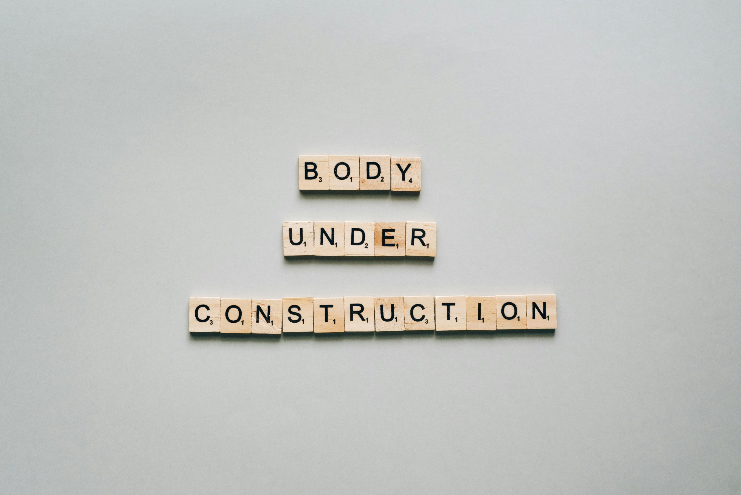 "Body under construction" written in scrabble letters
