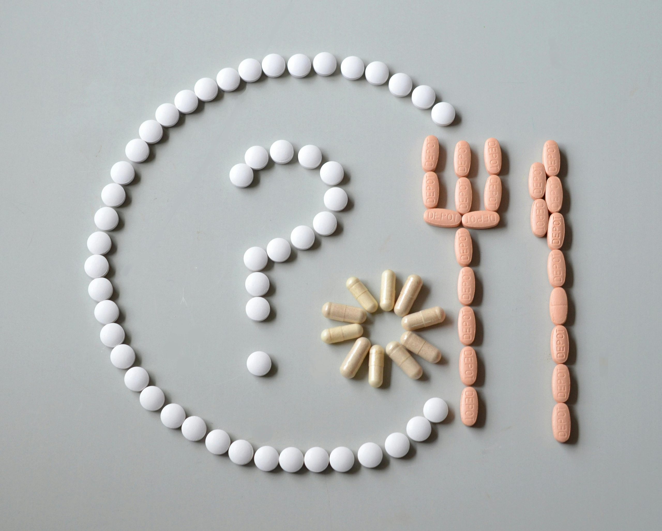 A plate and cutlery with a questions mark made out of pills